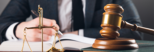 judge-takes-notes-table-scales-hammer-gray-surface